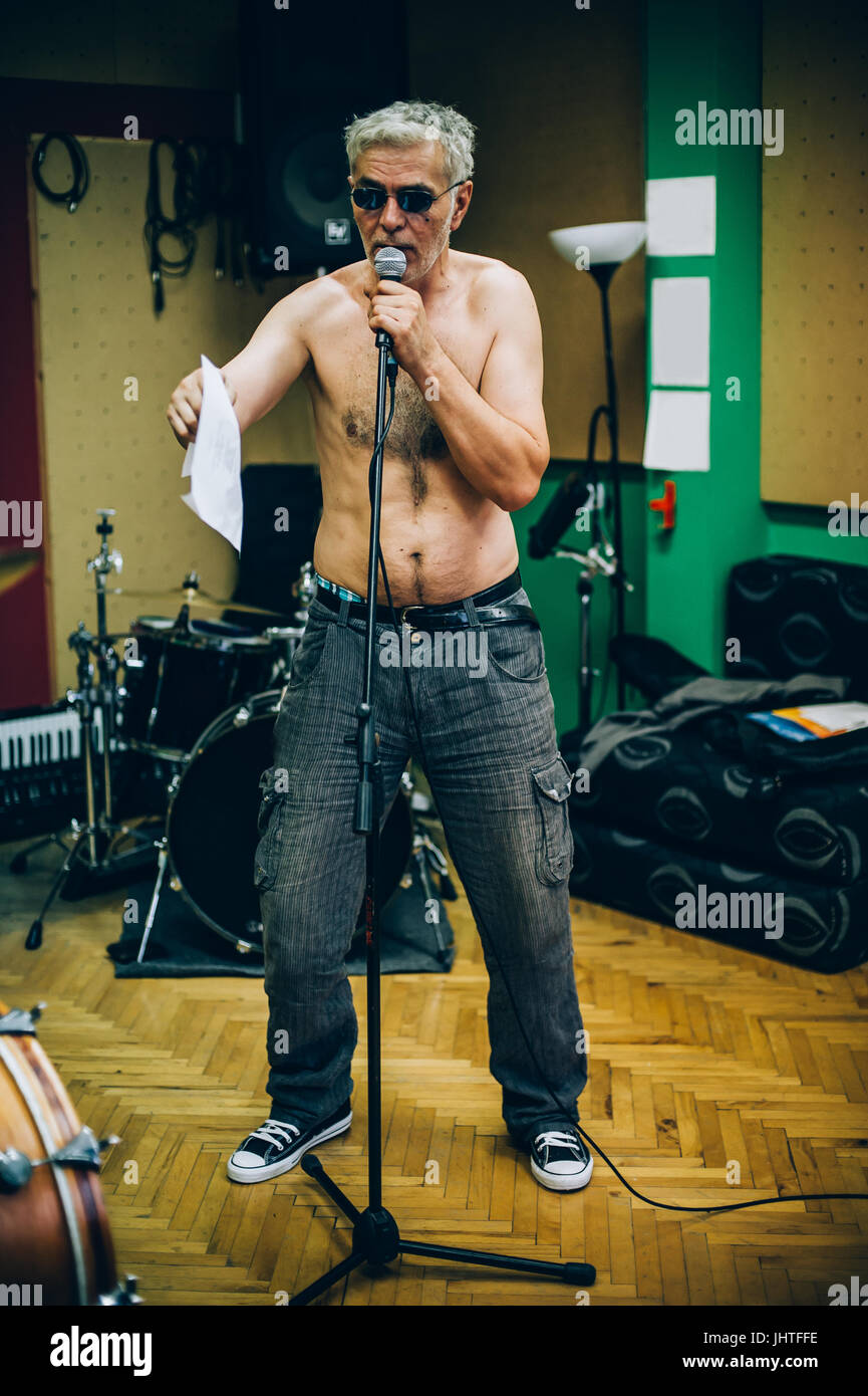 Behind the scene. Famous alternative male singer practice singing on