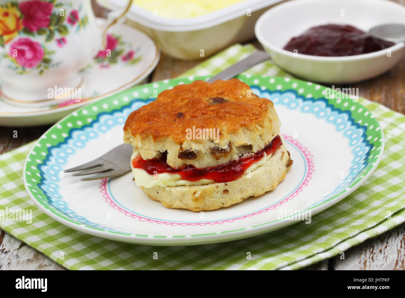 Traditional English scone with strawberry jam and fresh clotted cream Stock Photo