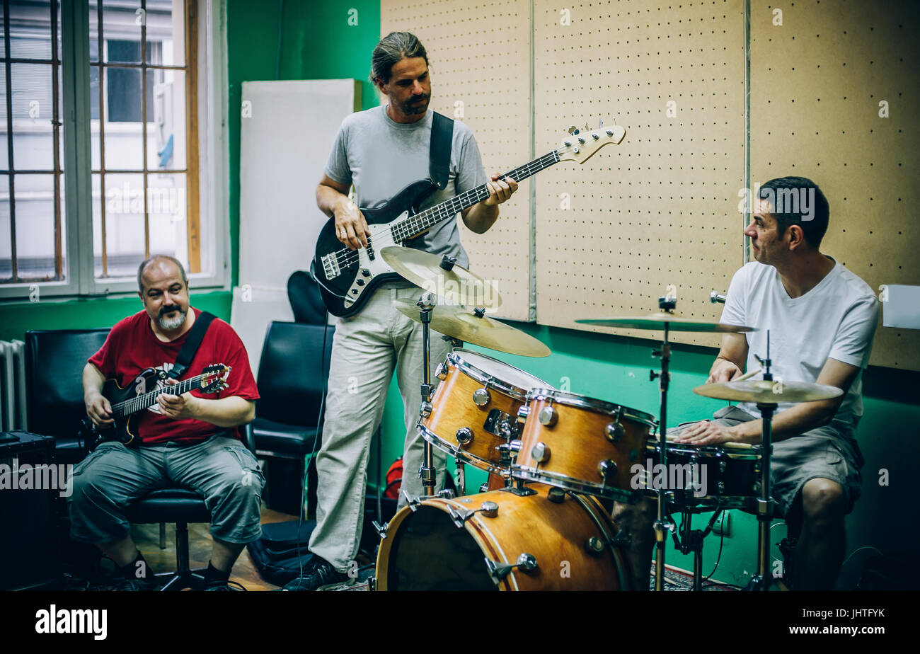 Behind the scene. Rock band practice in the messy recording music studio.  Alternative musician group live playing Stock Photo - Alamy