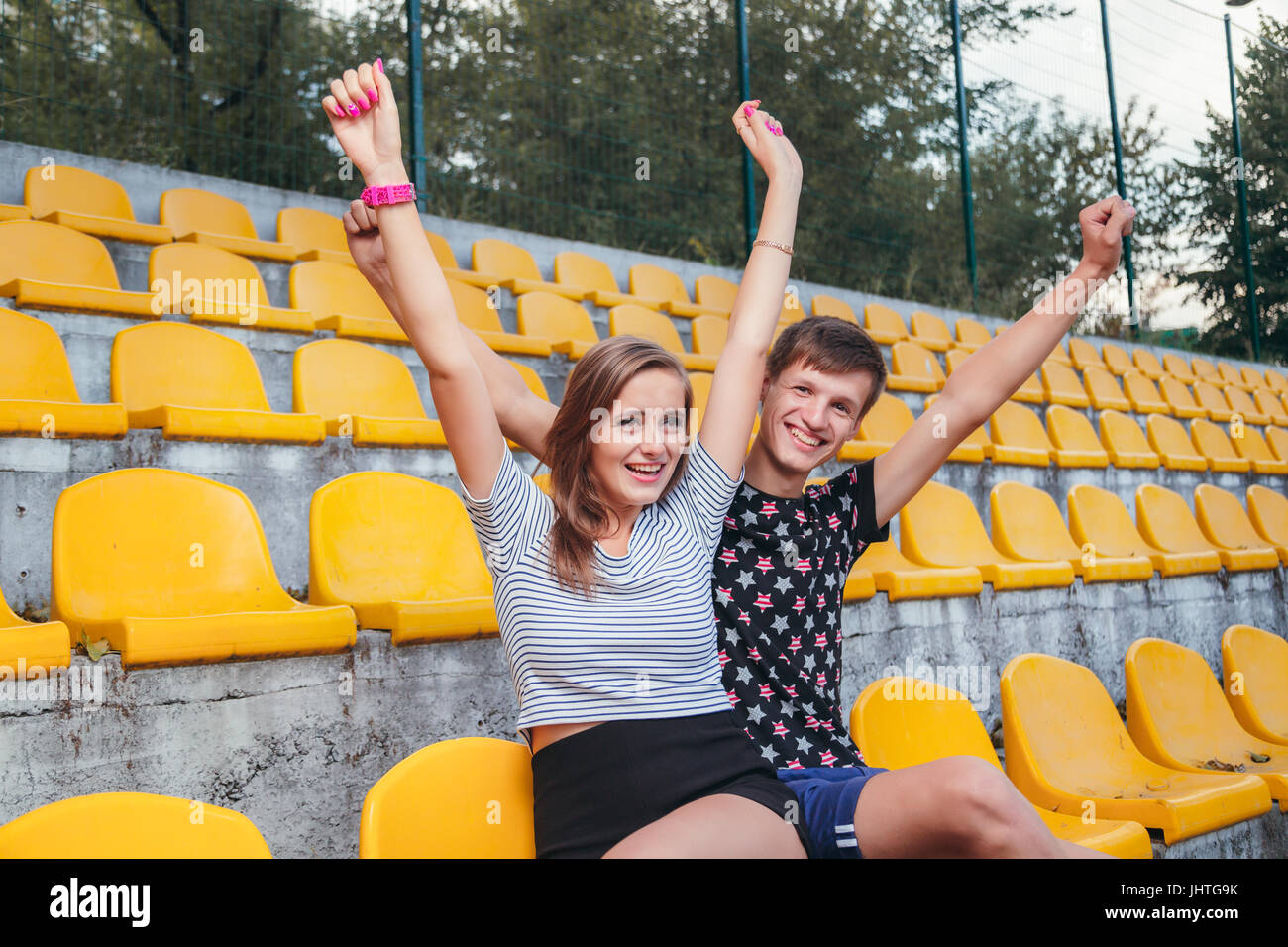 Young loving couple fan celebrating in the stadium Stock Photo