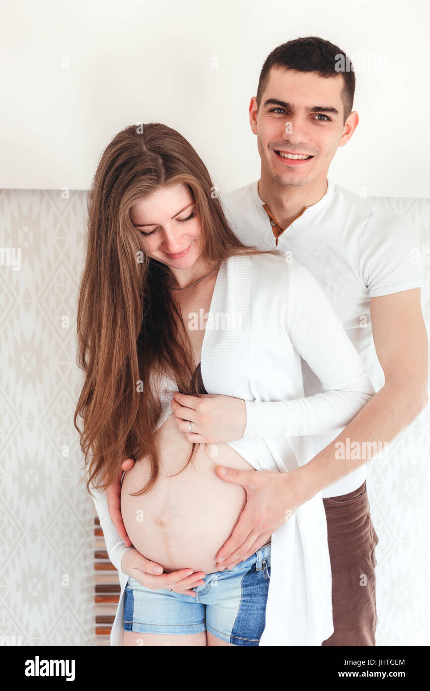Beautiful pregnant woman and her husband is in their bedroom Stock Photo