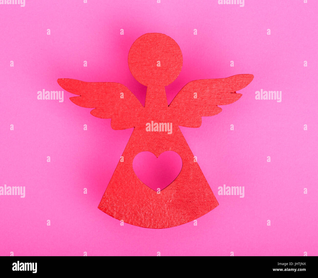 Christmas decorations of red angel on a pink background Stock Photo