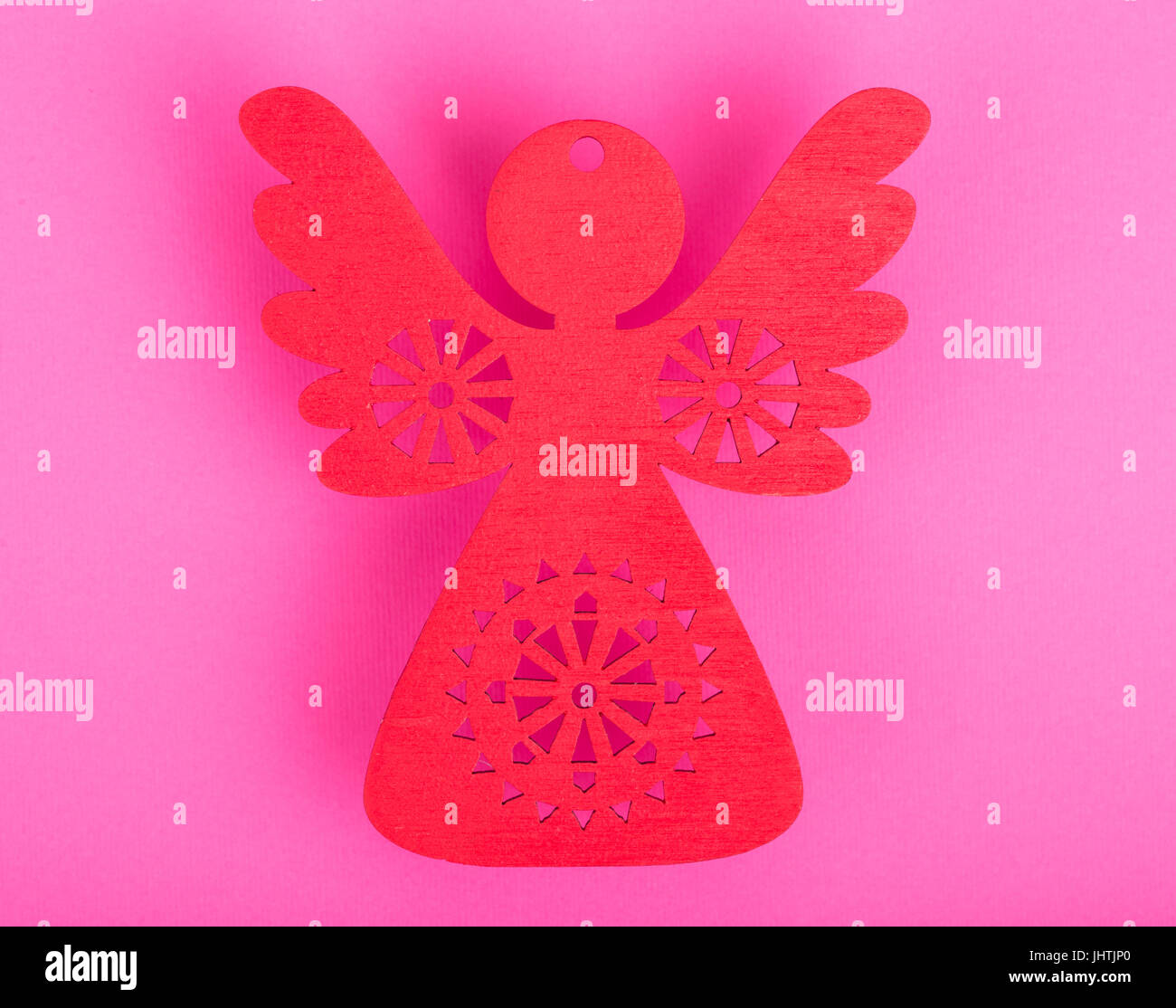 Christmas decorations of red angel on a pink background Stock Photo