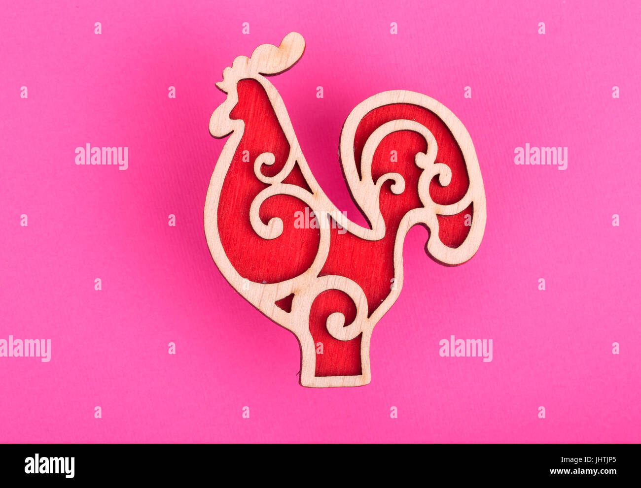 Christmas decorations red cock ob a pink background Stock Photo