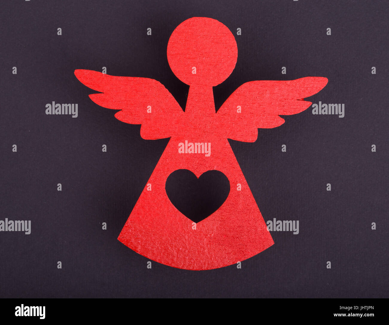 Christmas decorations of red angels on a black background Stock Photo