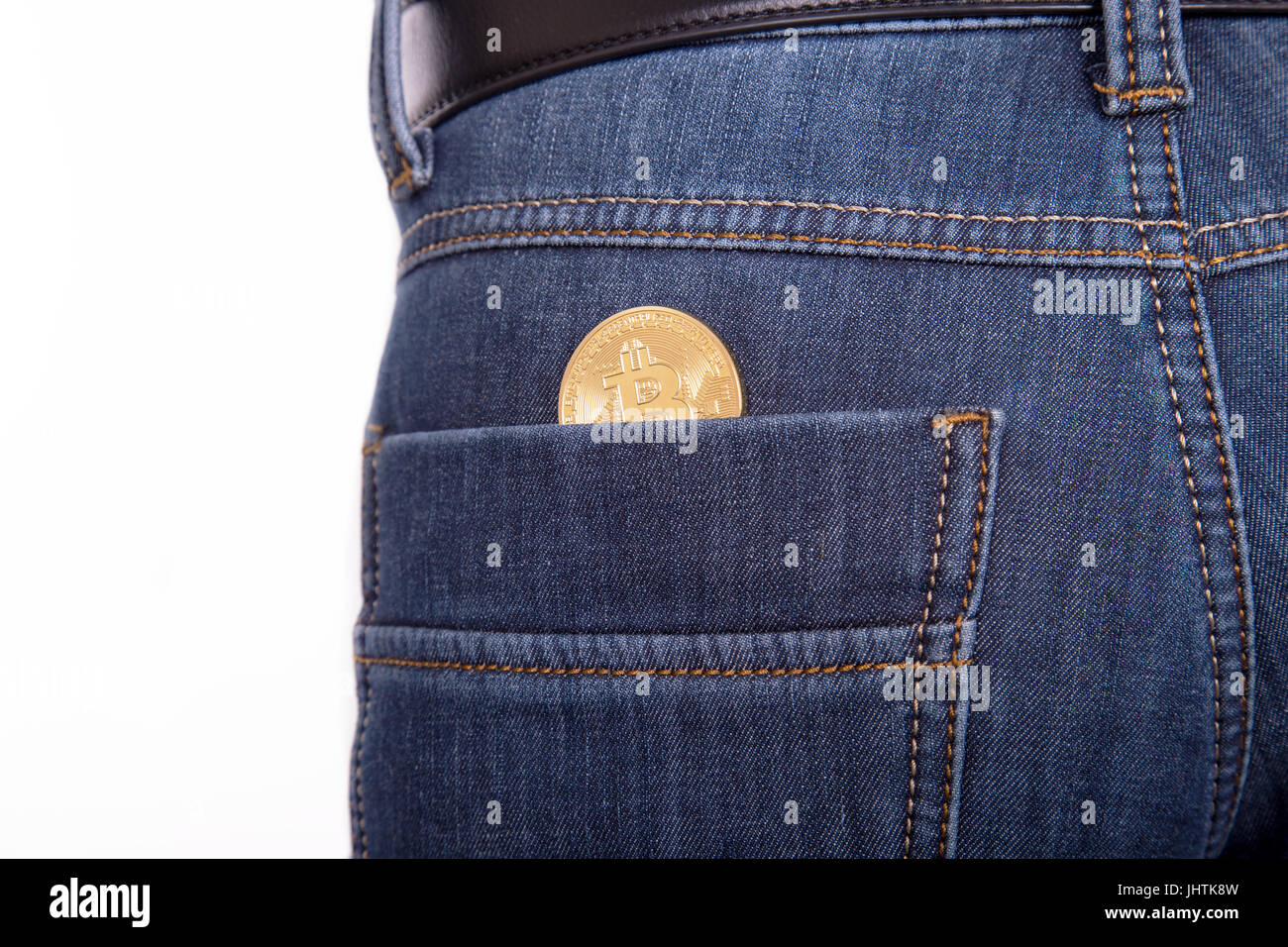 Golden bitcoin in pocket jeans man on white background Stock Photo