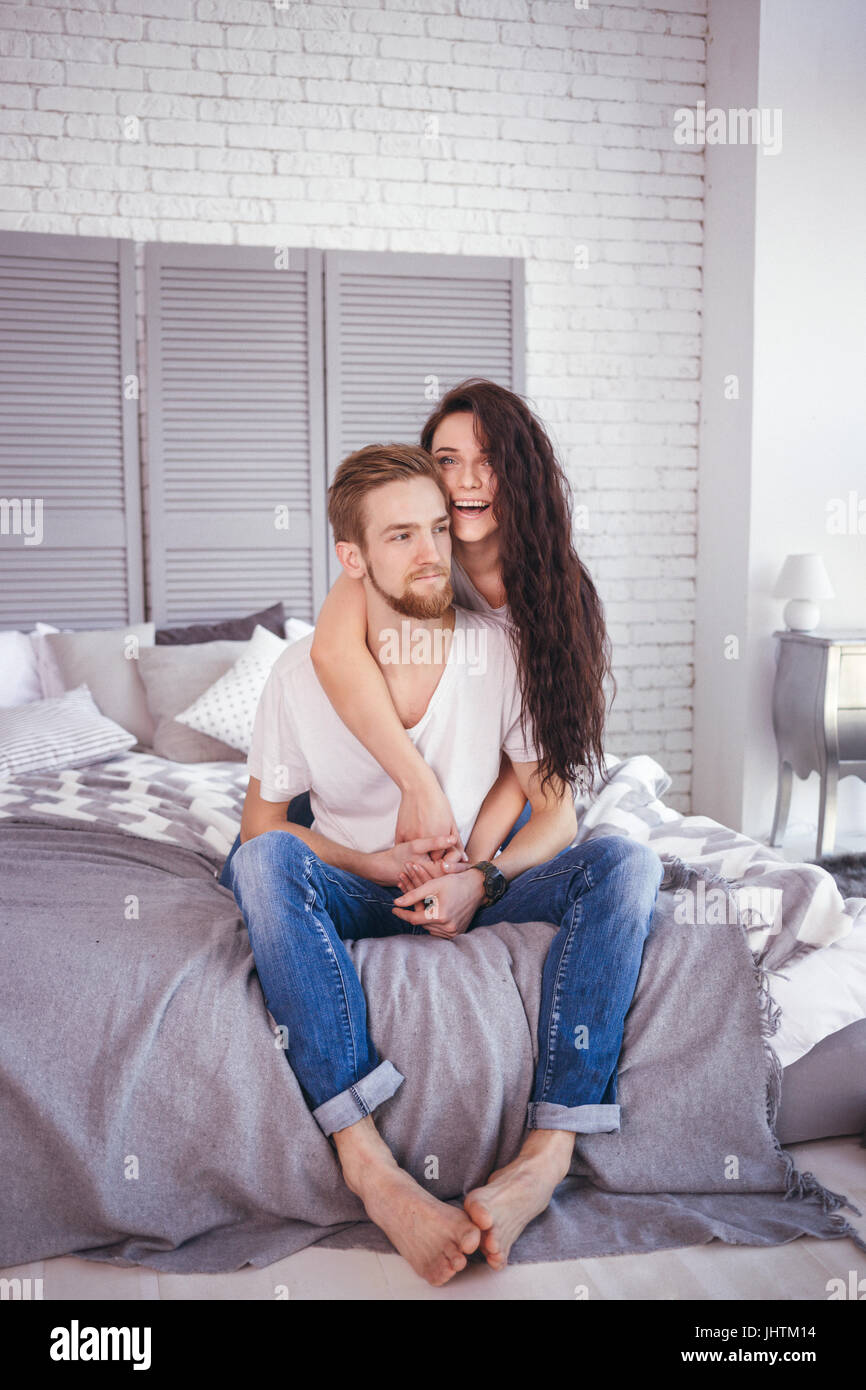 Young loving couple in the bed. Lifestyle Stock Photo
