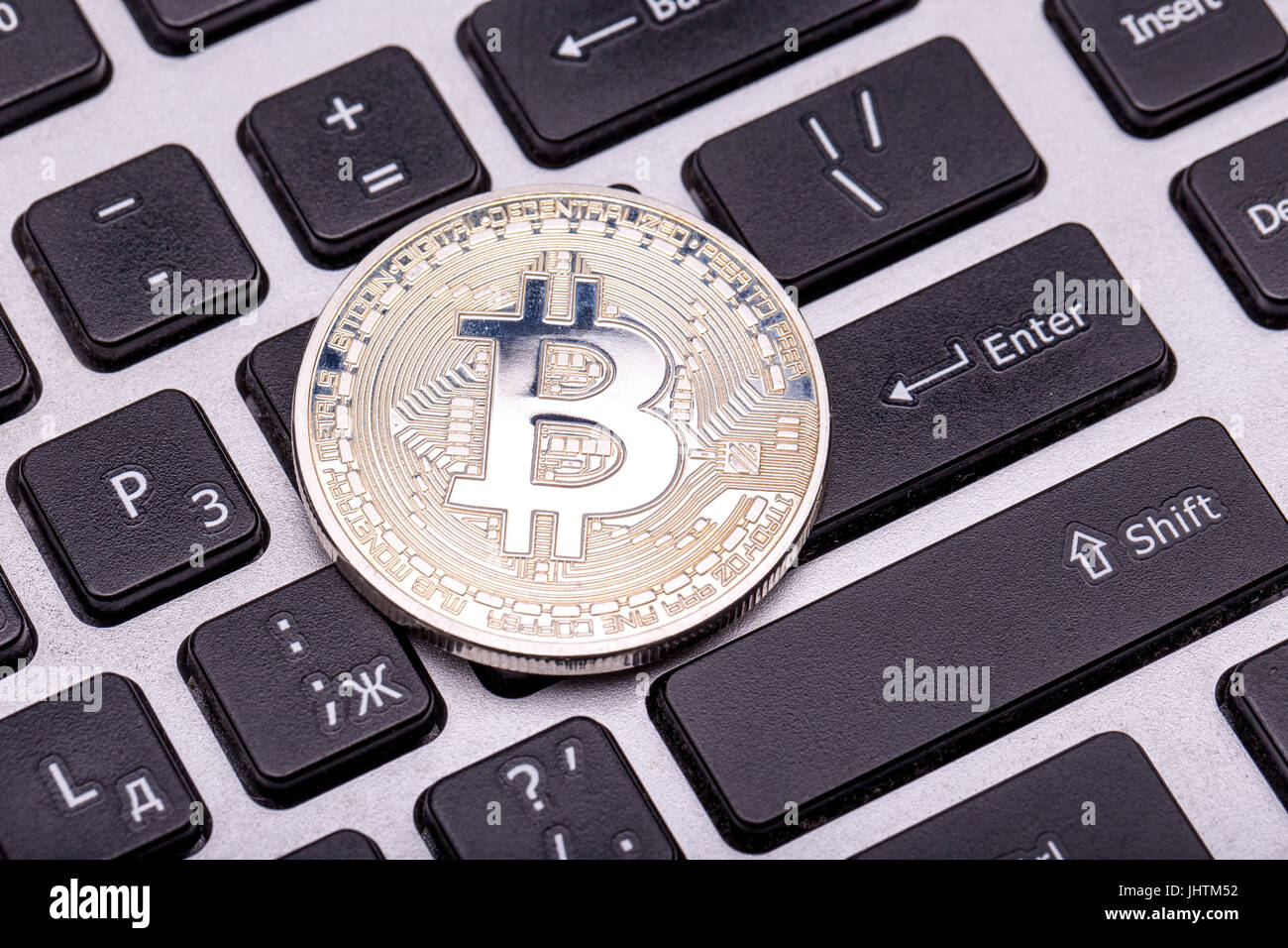 silver bitcoin on keyboard Stock Photo