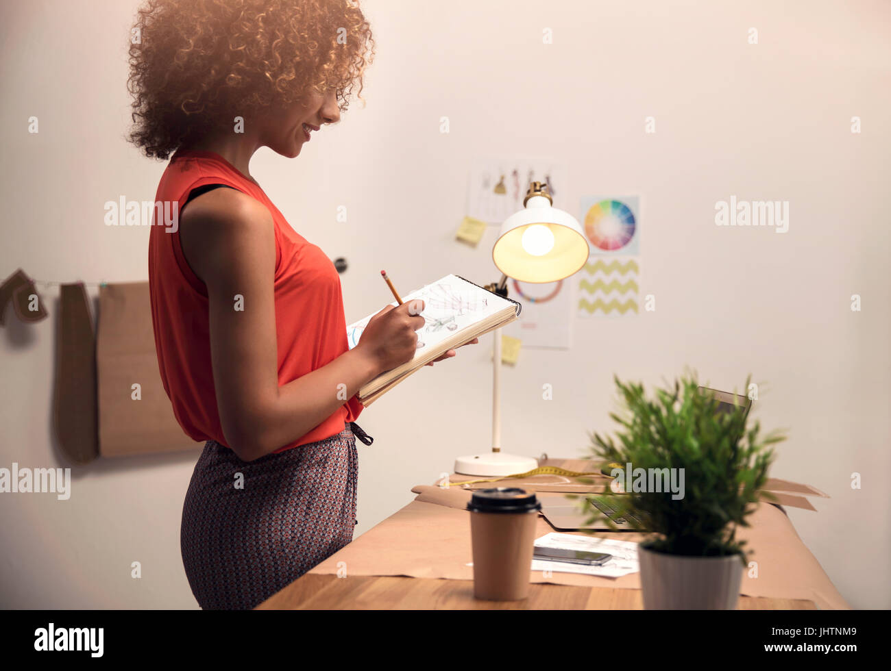 A young fashion designer working on her atelier Stock Photo - Alamy
