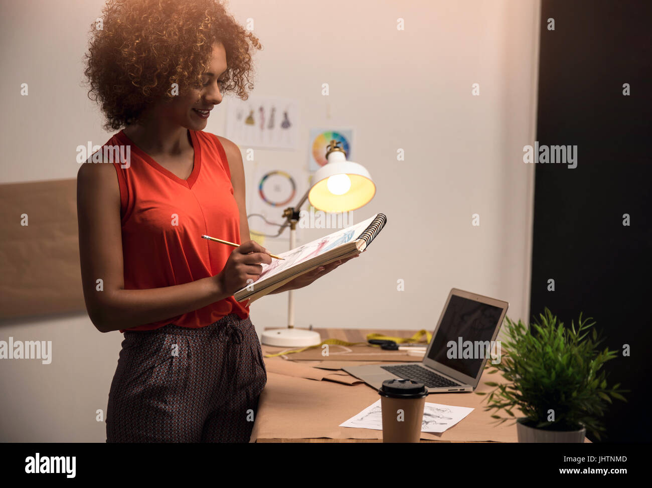 A young fashion designer working on her atelier Stock Photo - Alamy