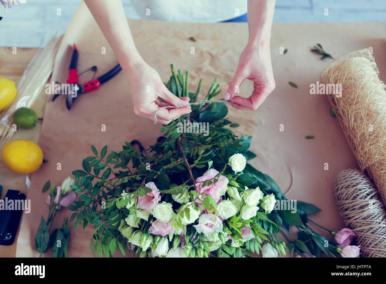 Florist makes composition of flowers Stock Photo Alamy