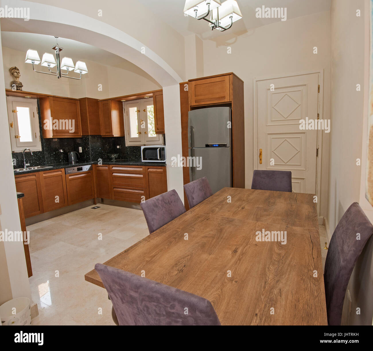 Kitchen and dining area in luxury apartment show home showing interior design decor furnishing Stock Photo