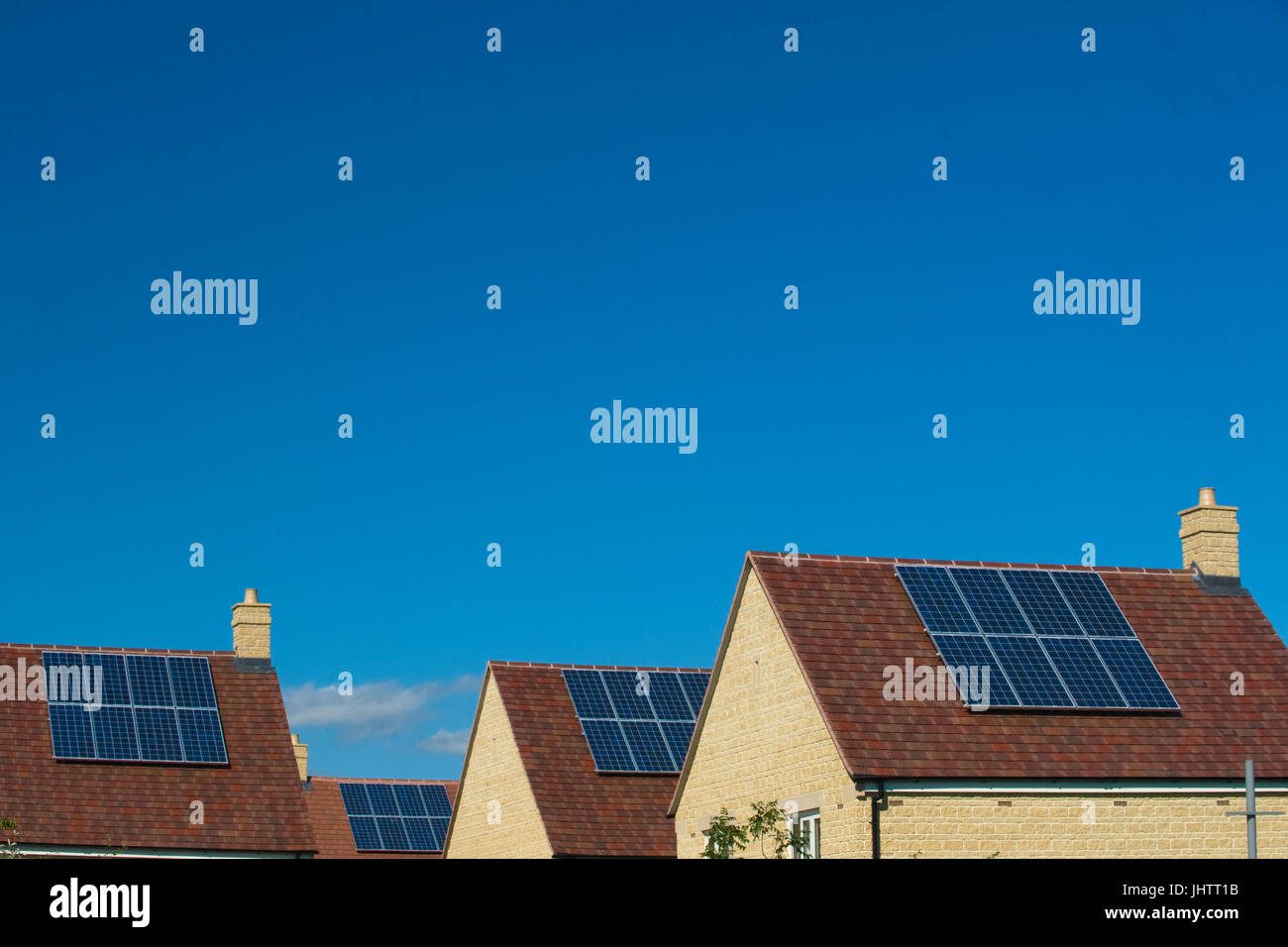 Solar panels fitted to the roofs of domestic houses during construction in Oxfordhire, UK.solar panels Stock Photo