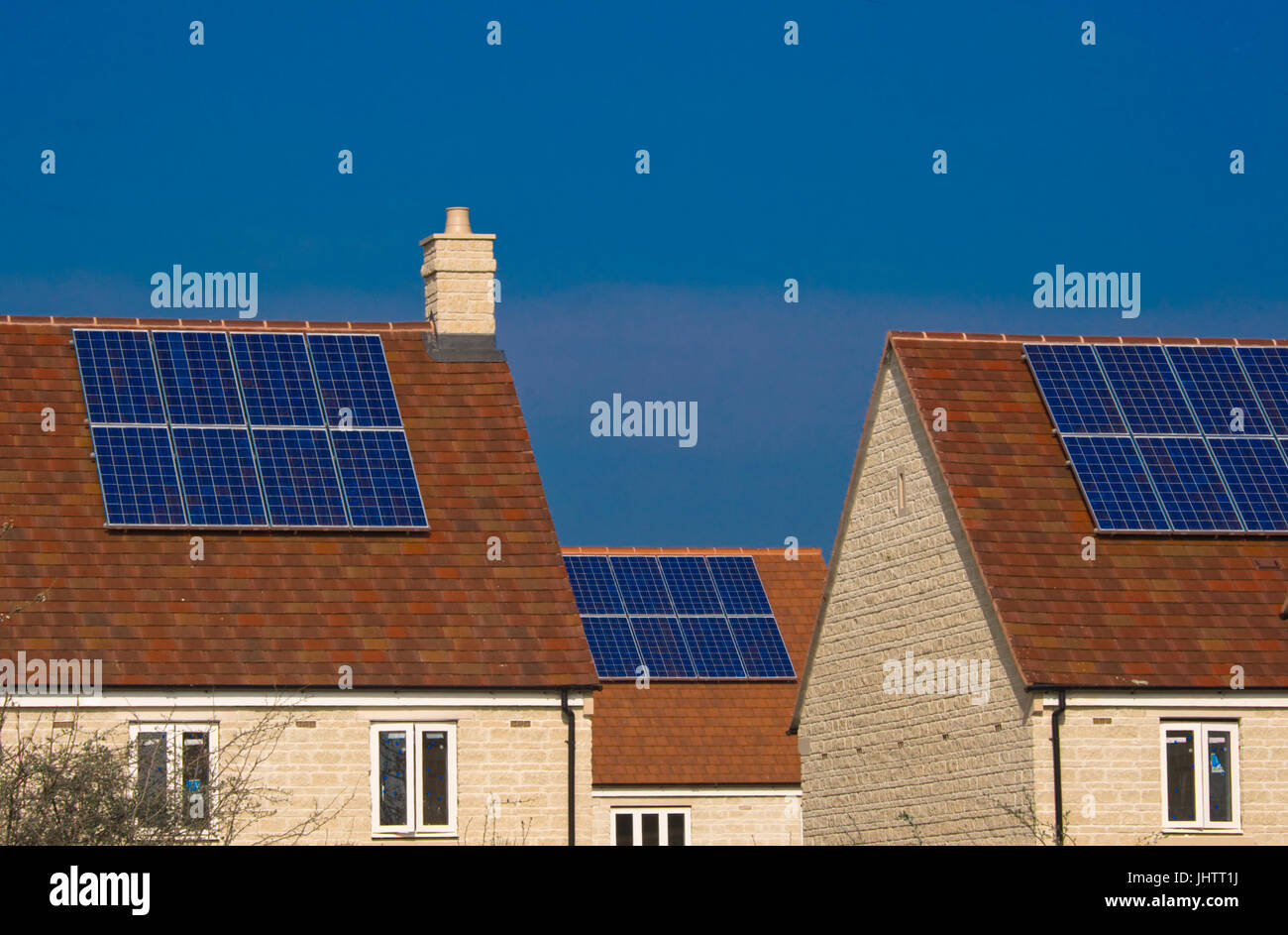 Solar panels fitted to the roofs of domestic houses during construction