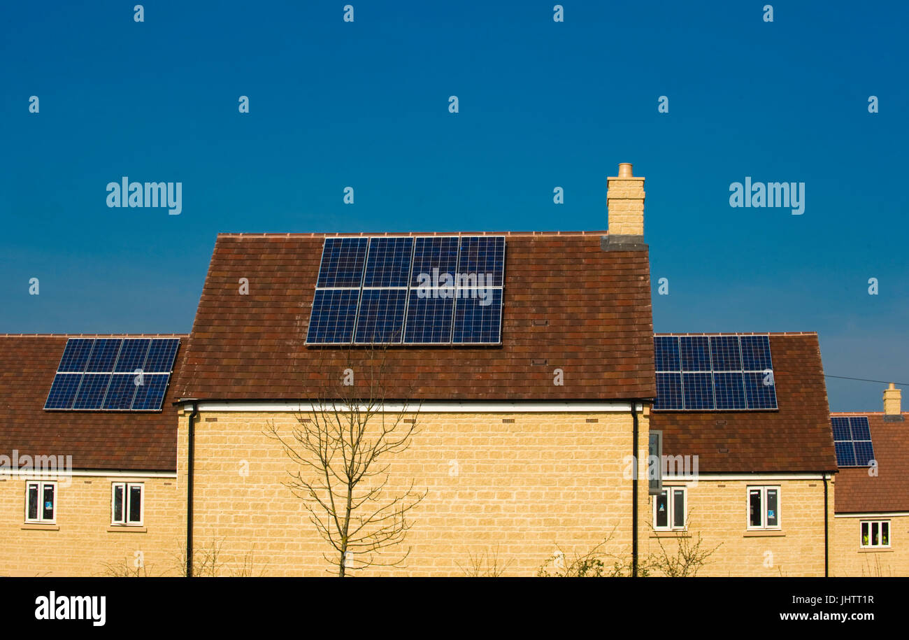 Solar panels fitted to the roofs of domestic houses during construction in Oxfordhire, UK.solar panels Stock Photo