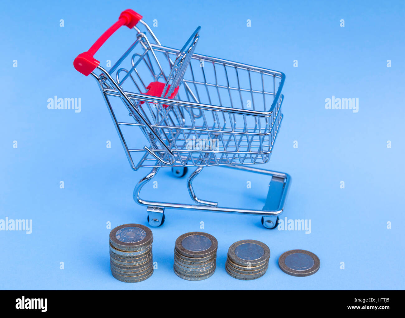 Shopping trolley full of one pound coins Stock Photo