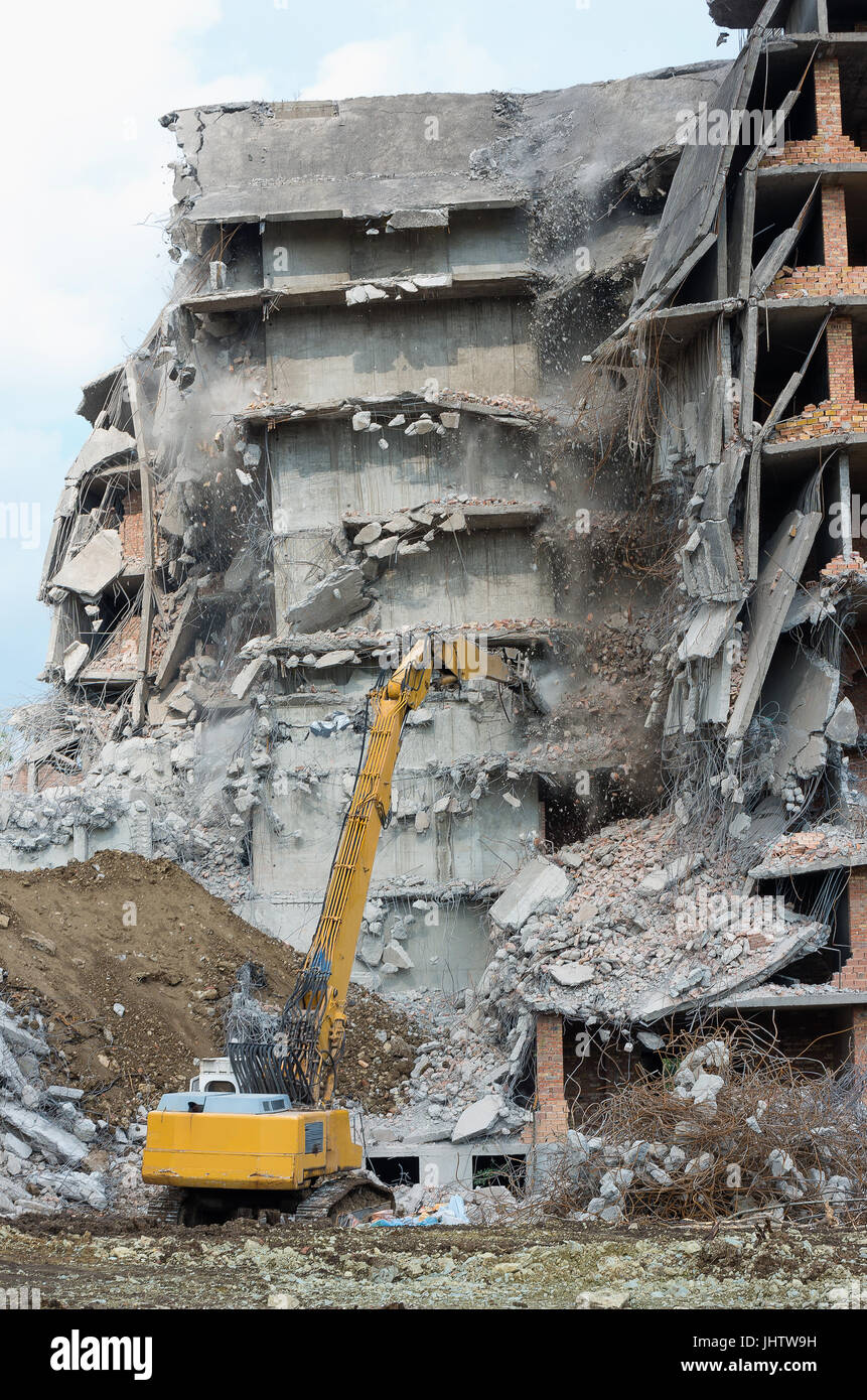Heavy equipment being used to tear tearing down building construction Stock Photo