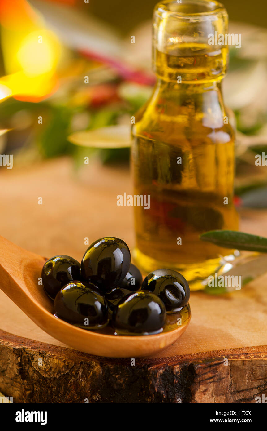 Olive oil and olive branch on the wooden table Stock Photo - Alamy