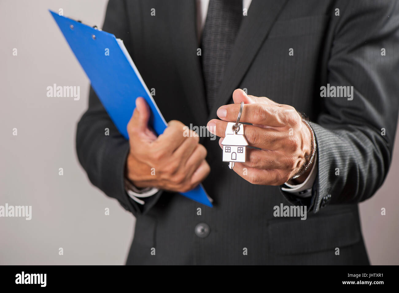 House key in businessman hand Stock Photo - Alamy