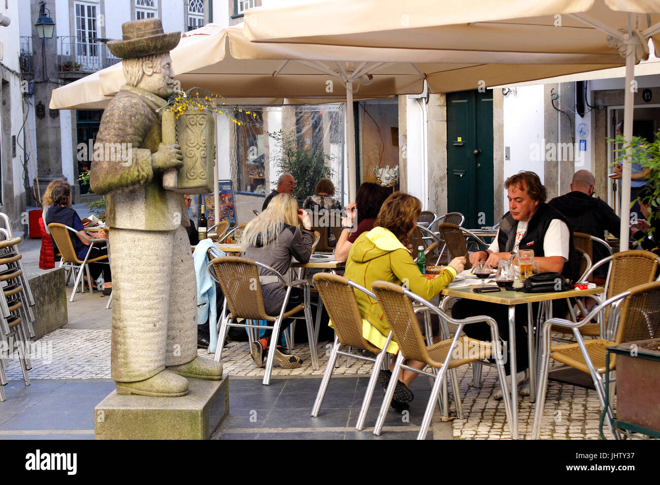 Statue tradition accordian player outside a small cafe Ponte de Lima Portugal Stock Photo