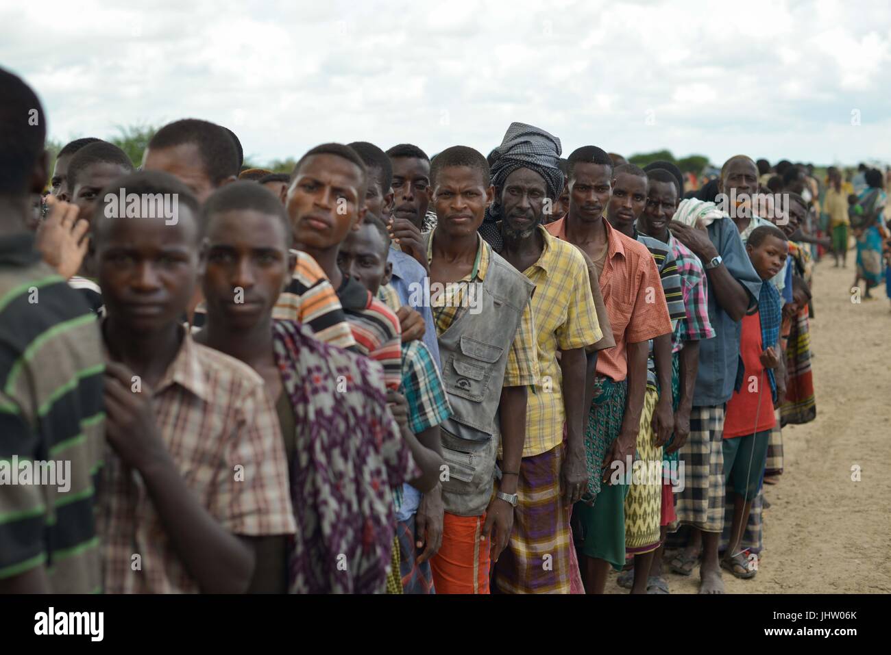 Somalian locals wait for a food handout at an IDP camp after being displaced by heavy rains November 12, 2013 in Jowhar, Somalia.    (photo by Tobin Jones  via Planetpix) Stock Photo