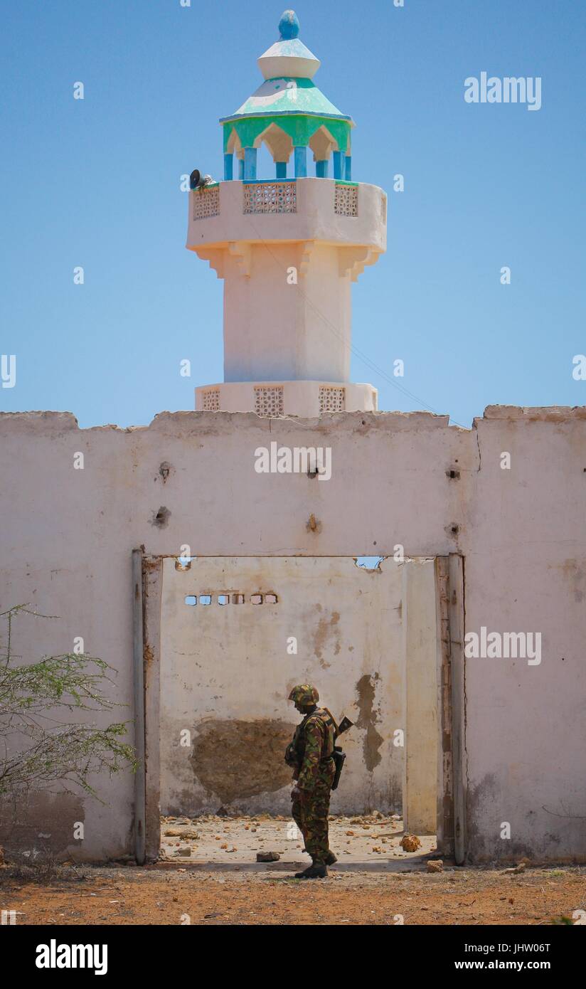 A Kenyan soldier searches next to a mosque for unexploded ordnance and improvised explosive devices left by the Al-Qaeda-affiliated extremist group Al Shabaab October 5, 2012 in Kismayo, Somalia.    (photo by Stuart Price  via Planetpix) Stock Photo