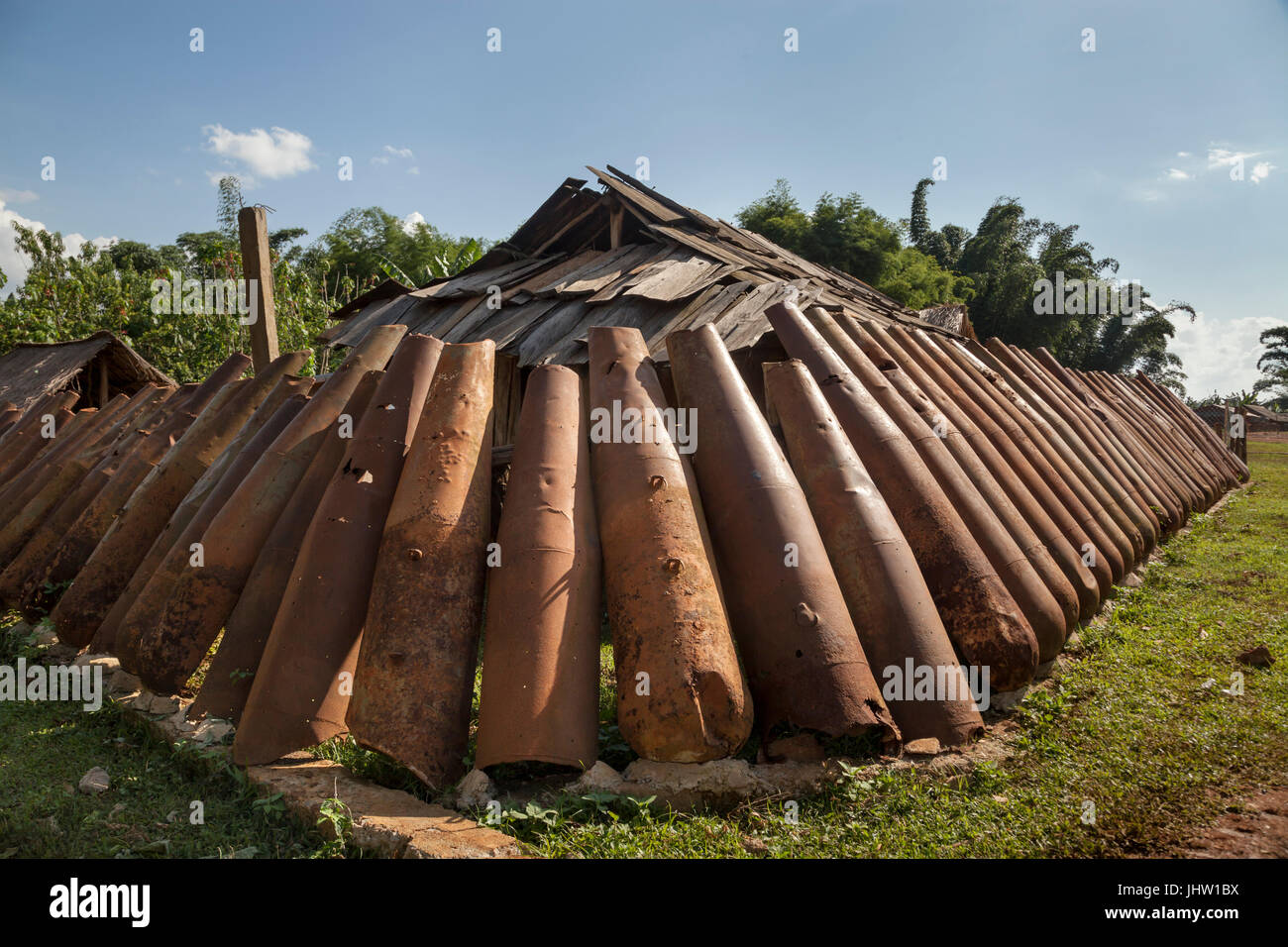 Deadly harvest left over from the Vietnam War. A wall of rusting American bomb casings recycled for use in Xiangkhouang, Province, Laos Stock Photo