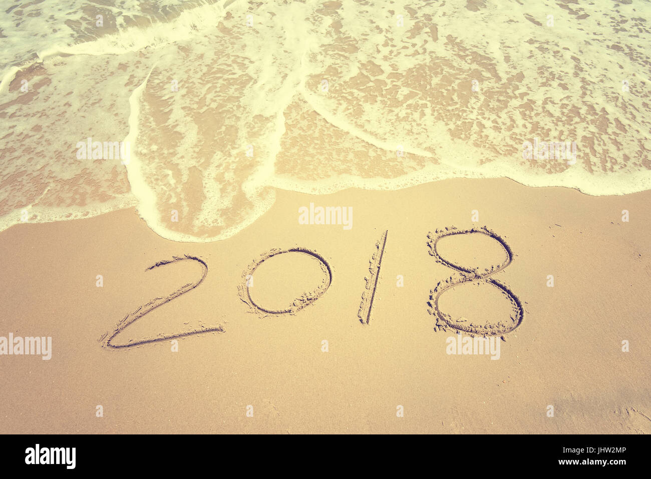 2018 written in sand write on tropical beach Stock Photo