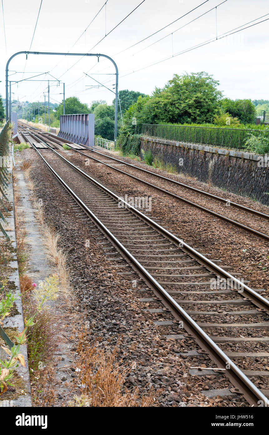 Railway lines crossing over a metal bridge in Redon France Stock Photo