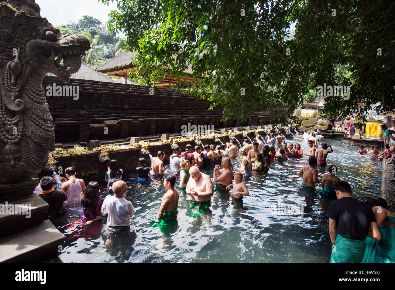 Balinese people in holy spring water of sacred pool at Pura Tirta Empul Temple, Tampaksiring, Bali, Indonesia Stock Photo