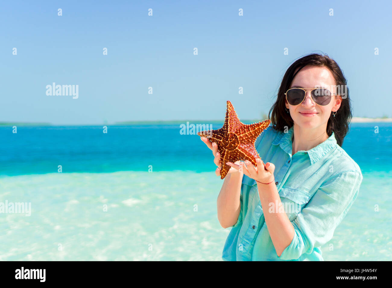 Adorable Girl With Starfish On The Beach Stock Photo Alamy