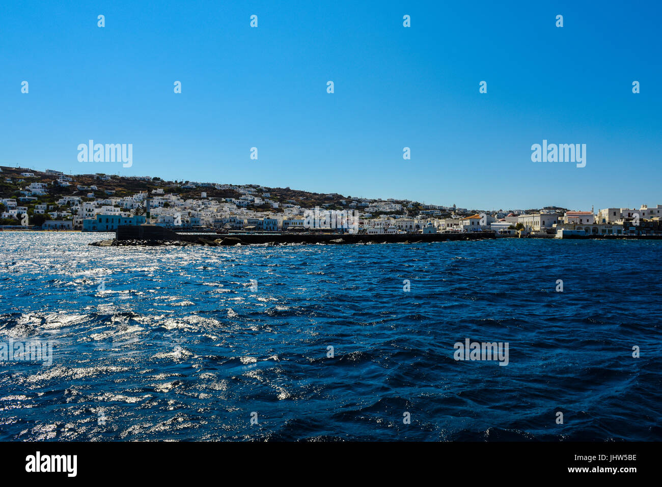 Entering Harbor with blue sky and blue water, Mykonos, Greece Stock Photo