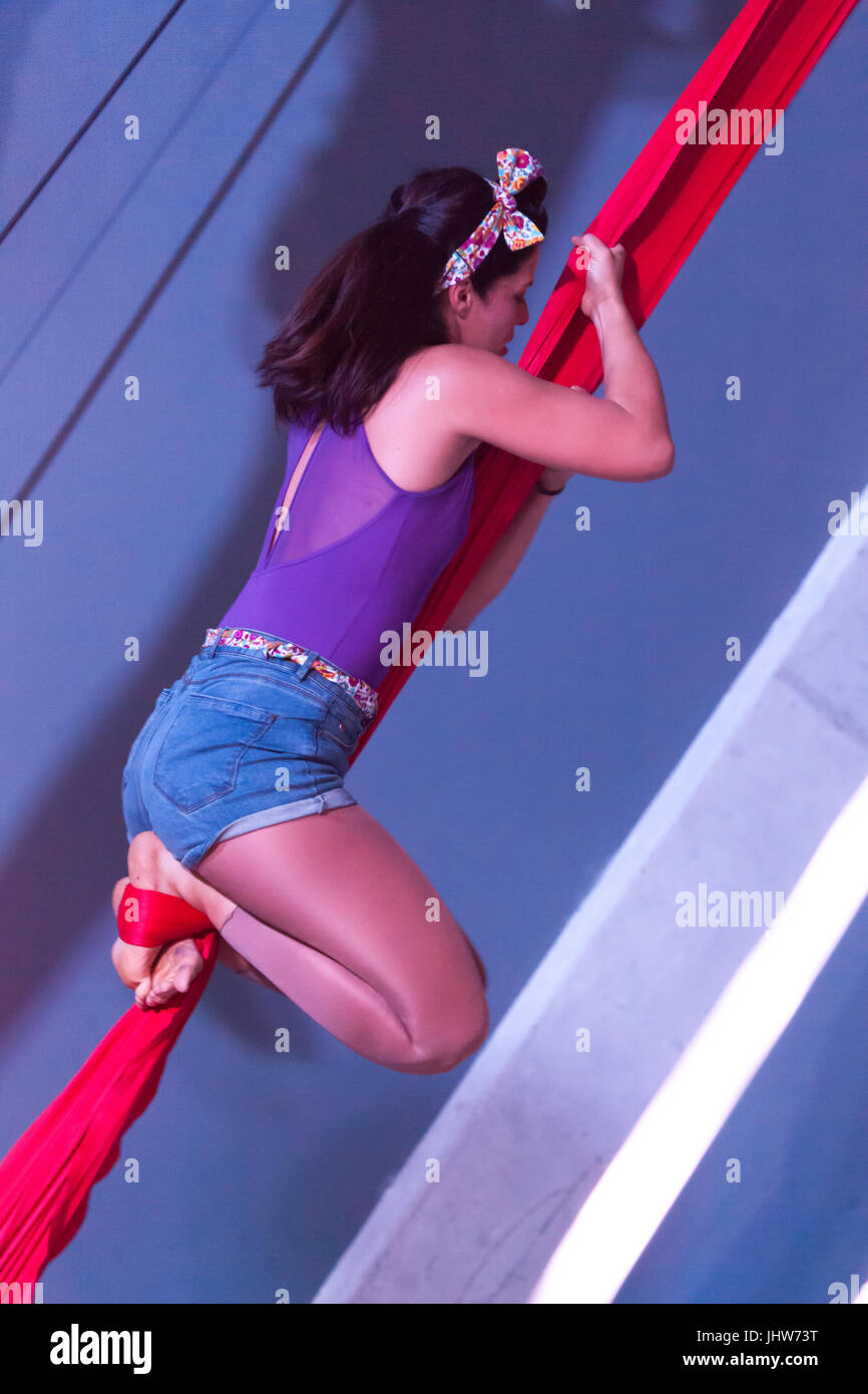 acrobats hanging on a rope by their legs Stock Photo - Alamy
