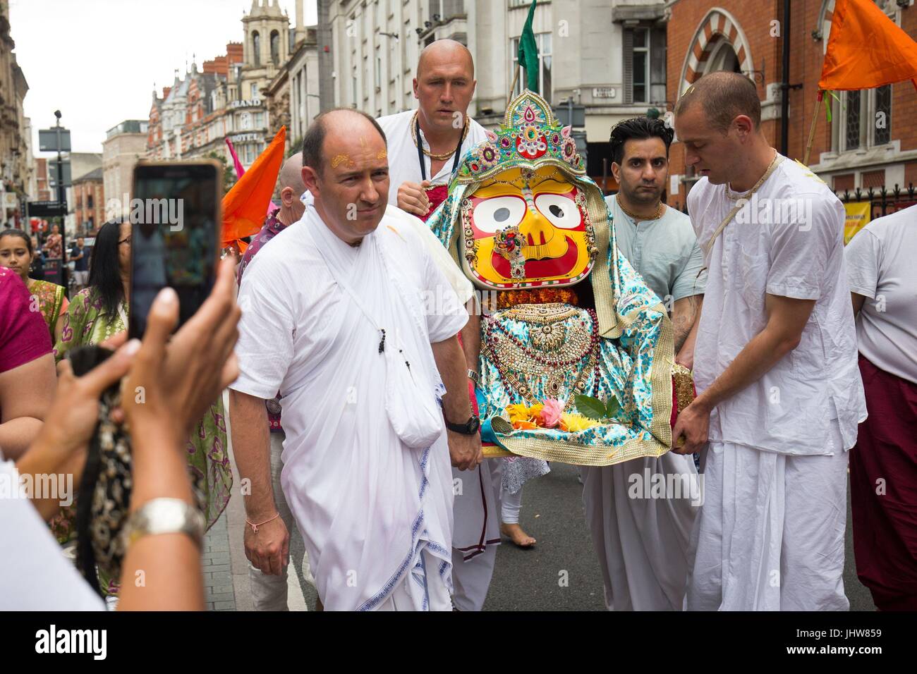 Festival-goers carrying deity Subhadra, as the Hare Krishna Festival of Chariots gets under way as festival-goers gather to dance and pull a 40ft chariot through Leicester City Centre in Leicester. Stock Photo