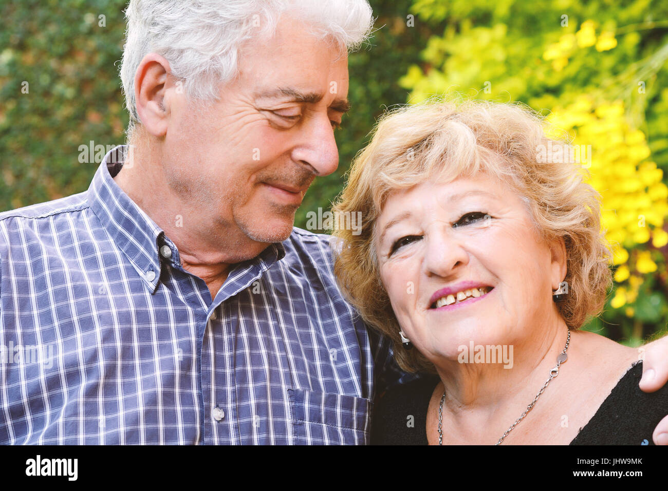 Portrait of an elderly couple sitting outdoors Stock Photo - Alamy
