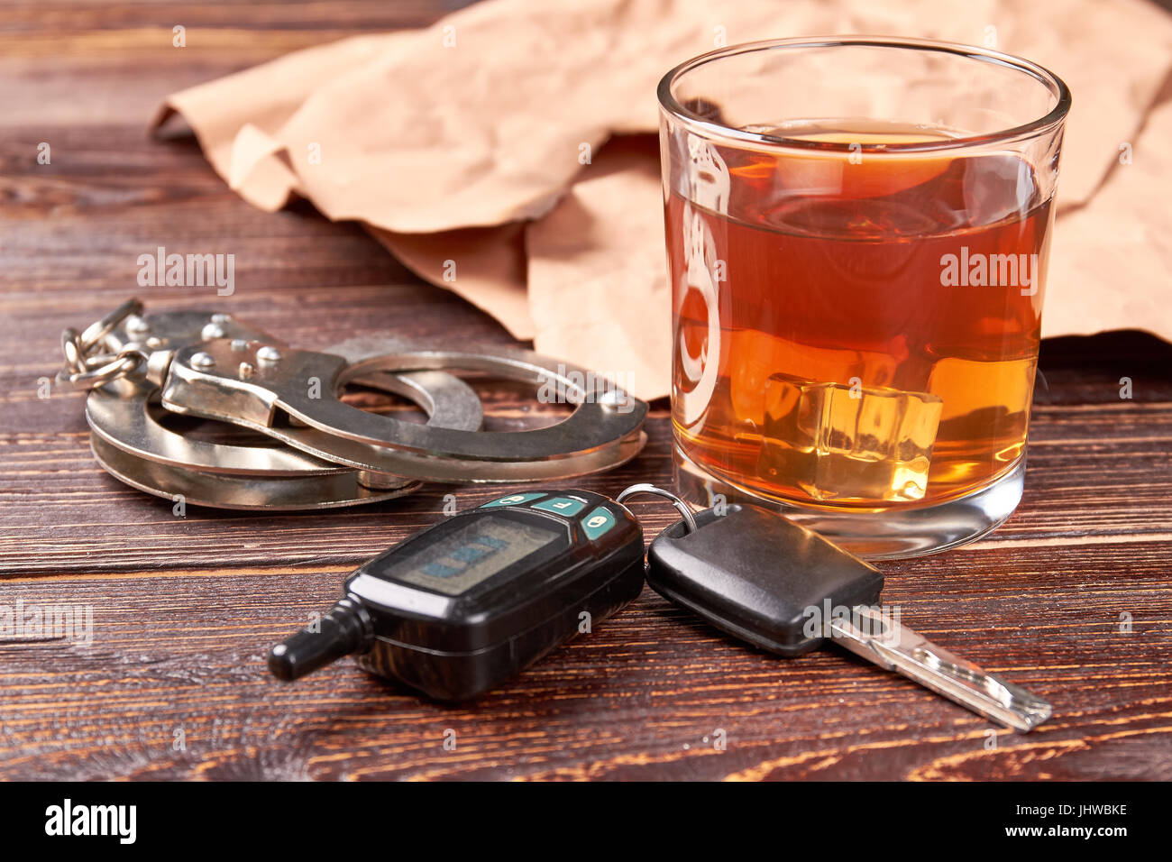Handcuffs, car keys, whisky glass Stock Photo Alamy