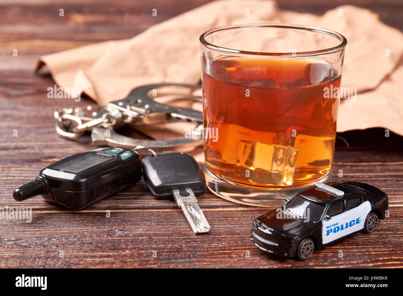Whiskey, keys, handcuffs, police car Stock Photo Alamy