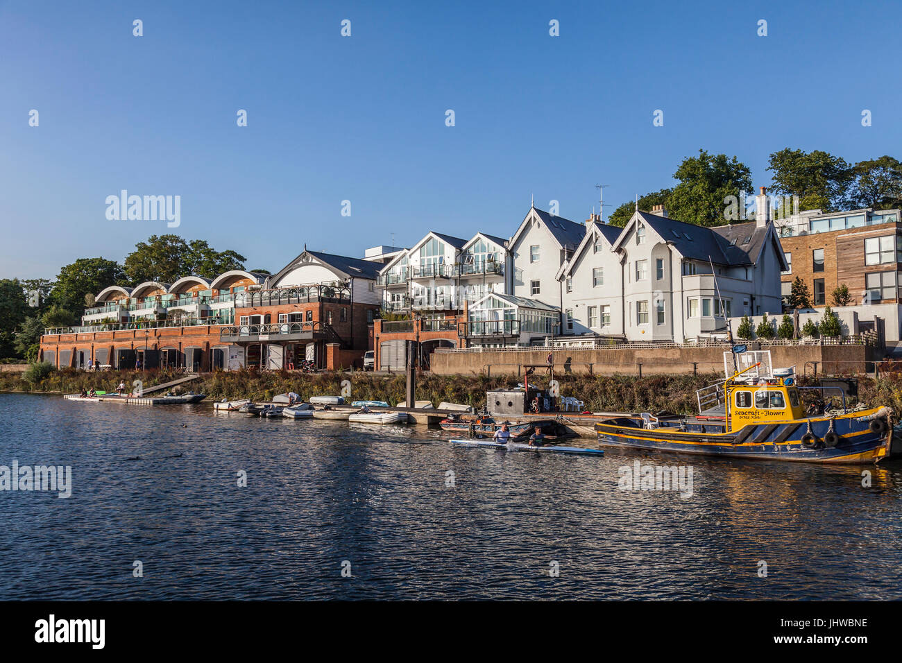 The River Thames flowing past Richmond Canoe Club. Kayakers are