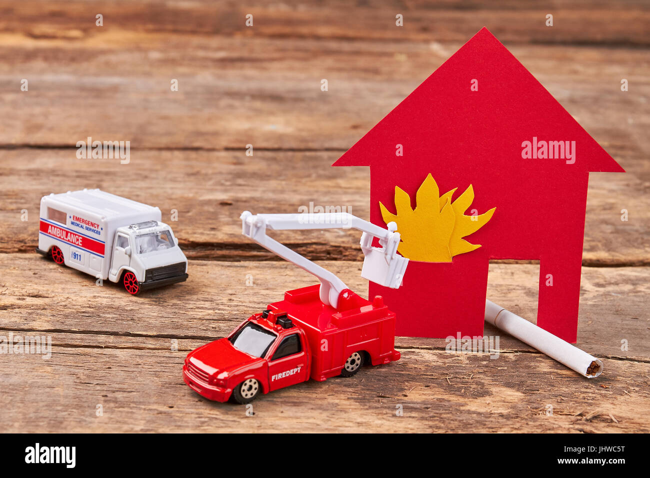 Toy ambulance, fire truck, flame. Stock Photo