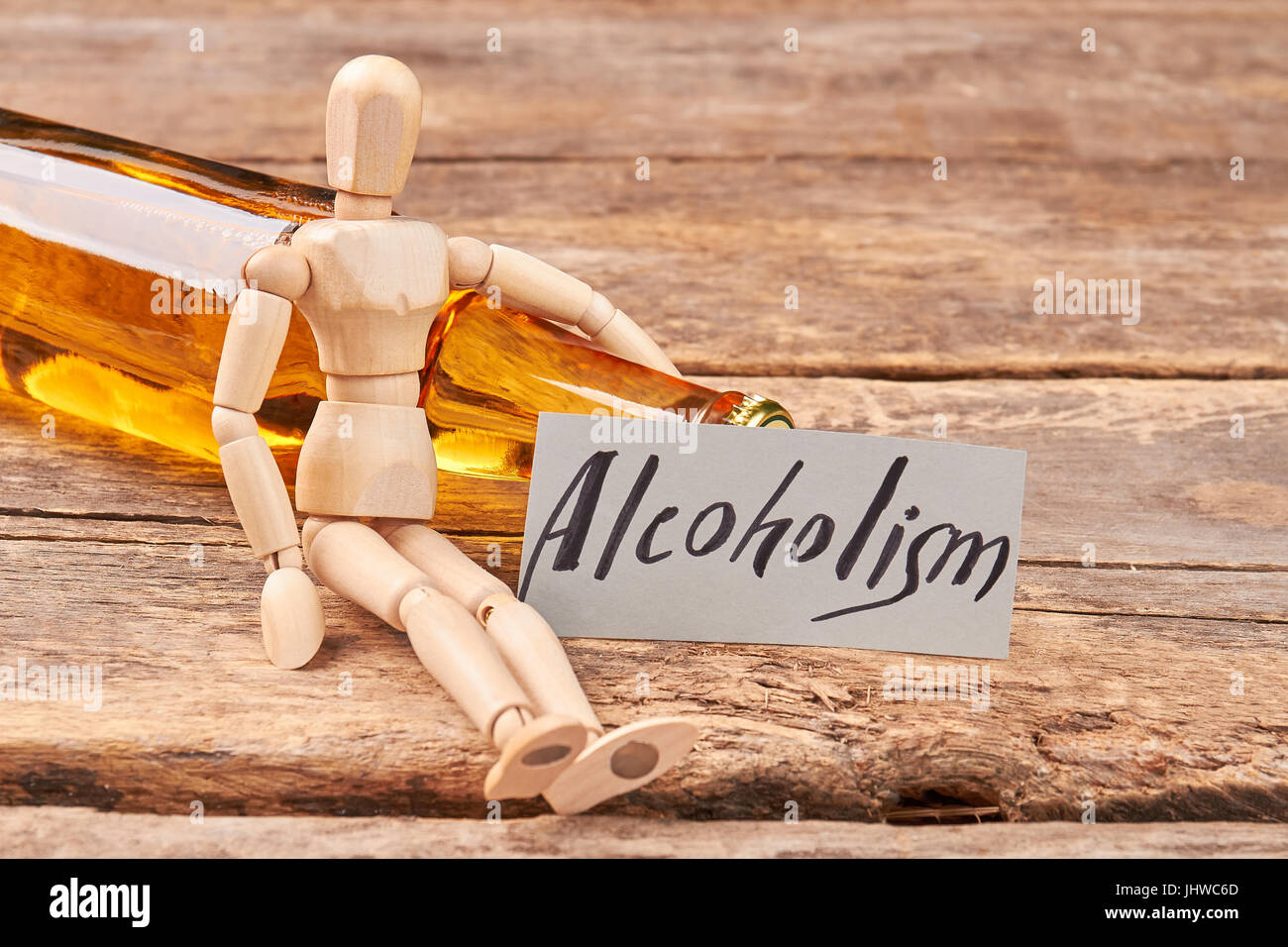 Human wooden dummy and alcohol. Stock Photo