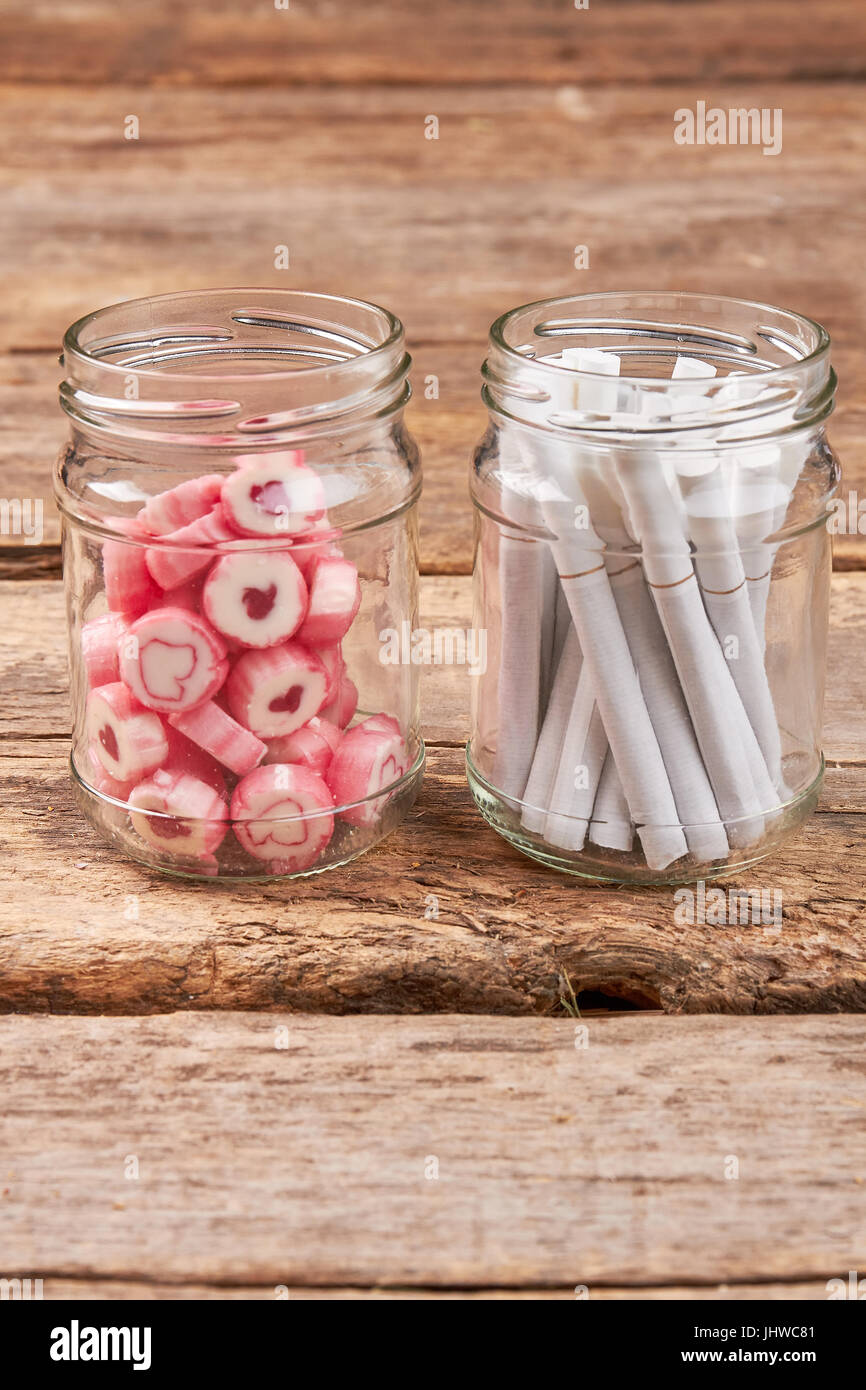 Glass jar with tobacco cigarettes. Stock Photo