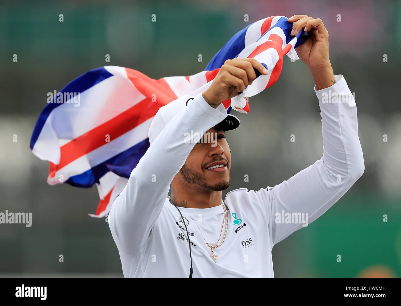 Mercedes' Lewis Hamilton waves to the crowd during the drivers parade at the 2017 British Grand Prix at Silverstone Circuit, Towcester. Stock Photo