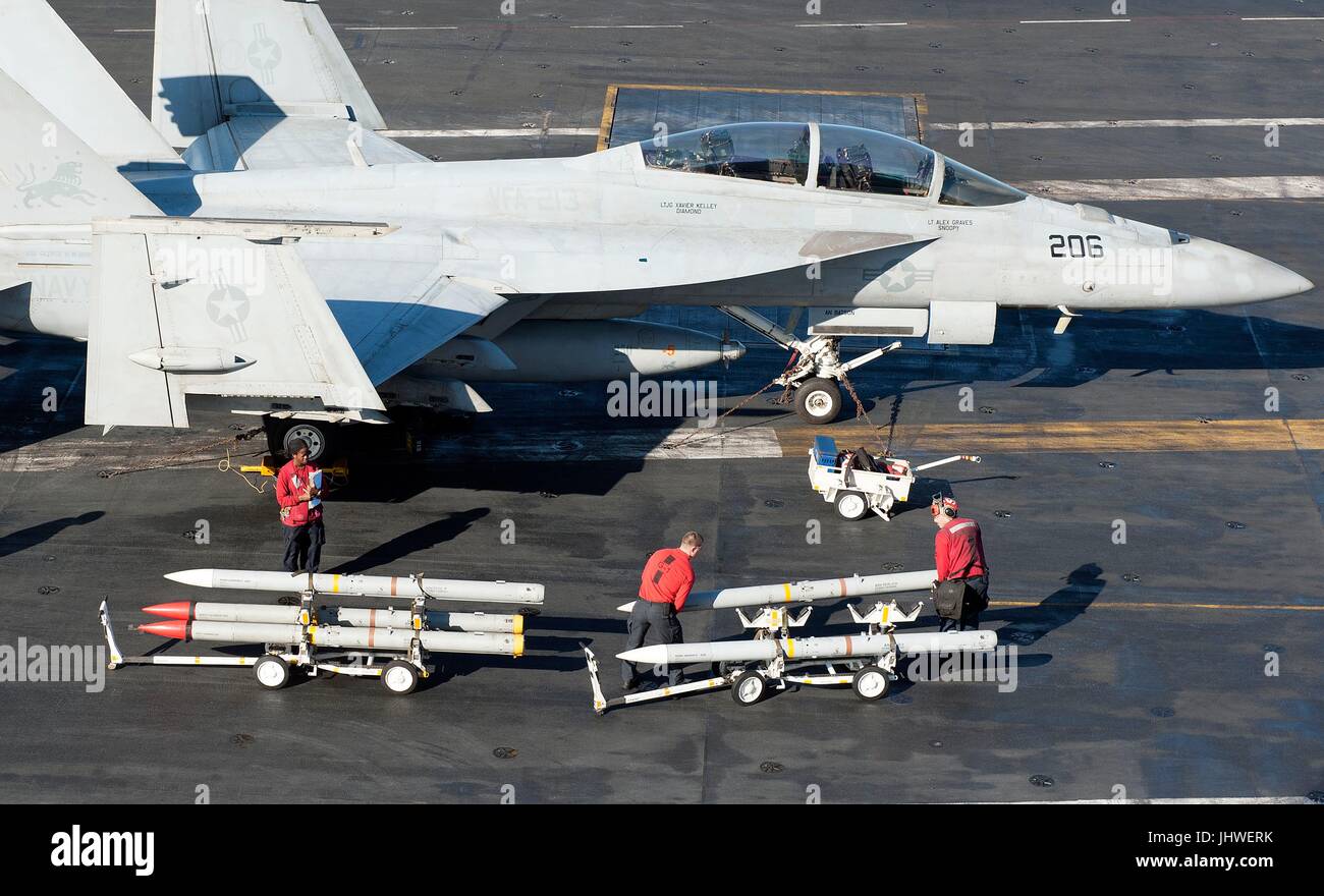us-sailors-transport-ordnance-on-the-flight-deck-aboard-the-us-navy-JHWERK.jpg