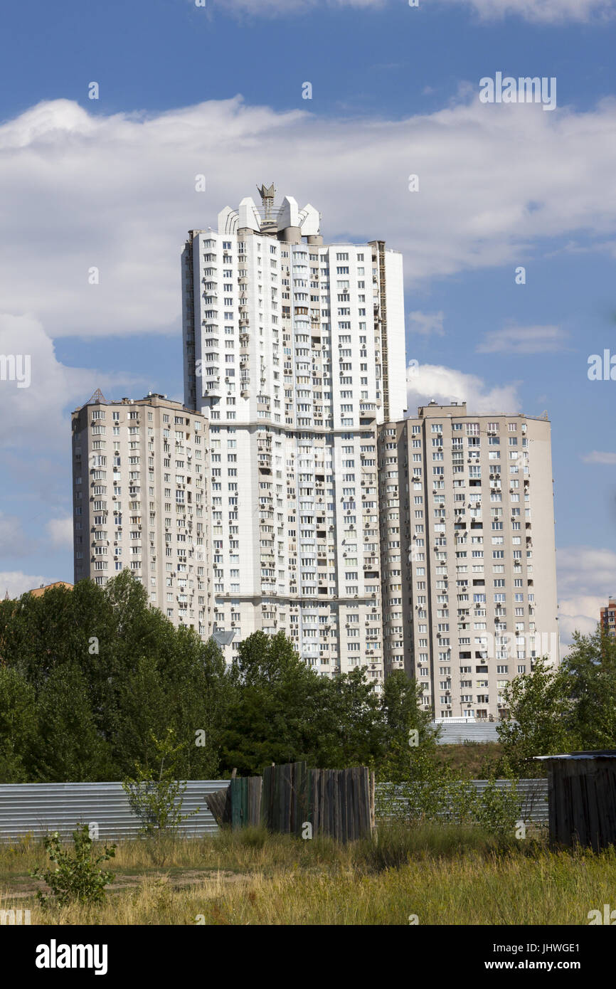 Construction site. Big industrial tower cranes with unfinished high raised  buildings and blue sky in background. Modern civil engineering Stock Photo  - Alamy
