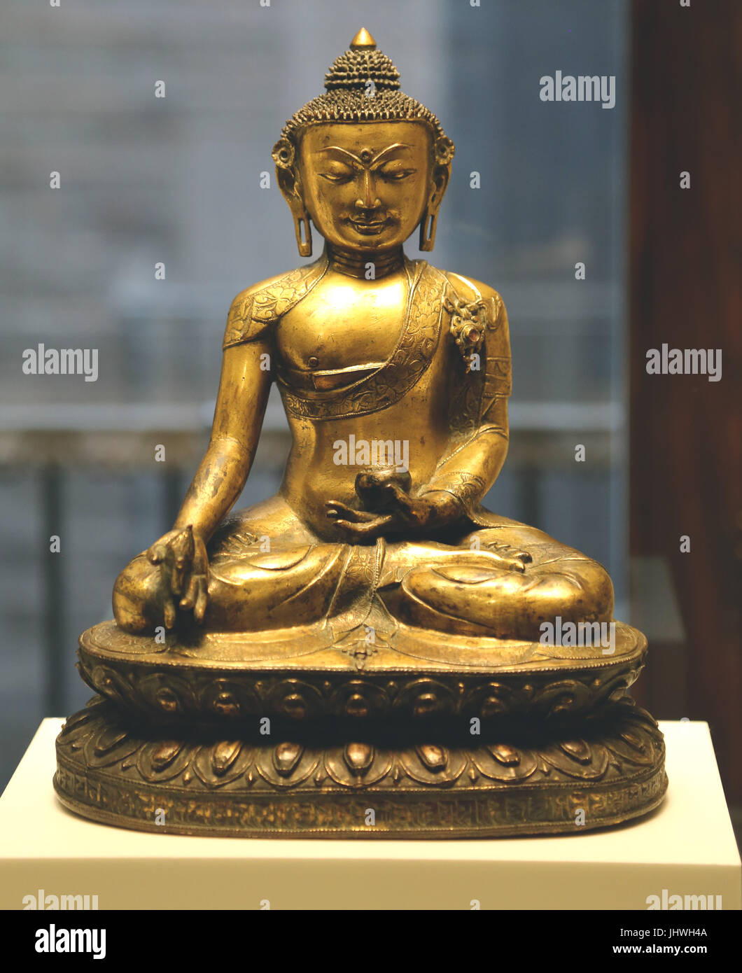 The Medicine Buddha, Bhaisajyaguru. Western Tibet, 18th and 19th century. Golden copper figure. King of healing. Stock Photo