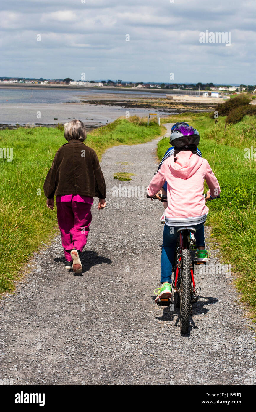 Family walk / cycle on trail at Martello Tower Dublin Ireland Stock Photo