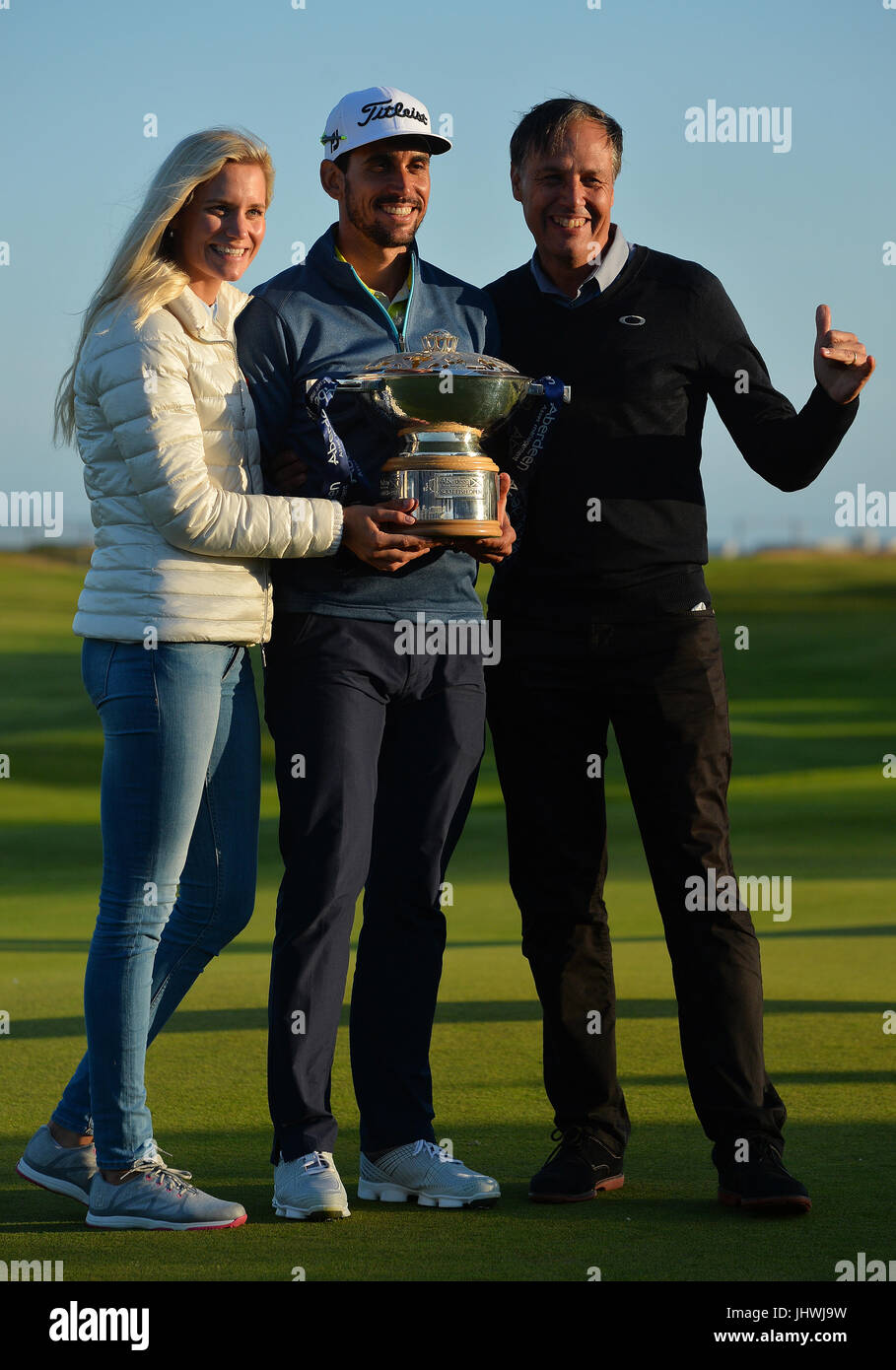 Spain's Rafa Cabrera Bello, girlfriend Sophia and manager Richard Rayment (right) with the trophy after winning the Aberdeen Asset Management Scottish Open during day four of the 2017 Aberdeen Asset Management Scottish Open at Dundonald Links, Troon. Stock Photo