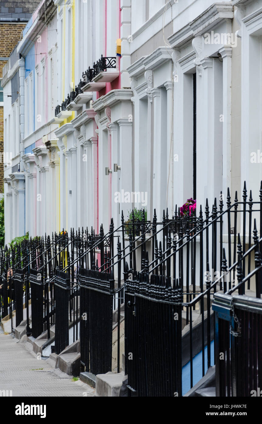 Terrace houses with black iron railings on Debbigh Terrace in Notting Hill, London. Stock Photo