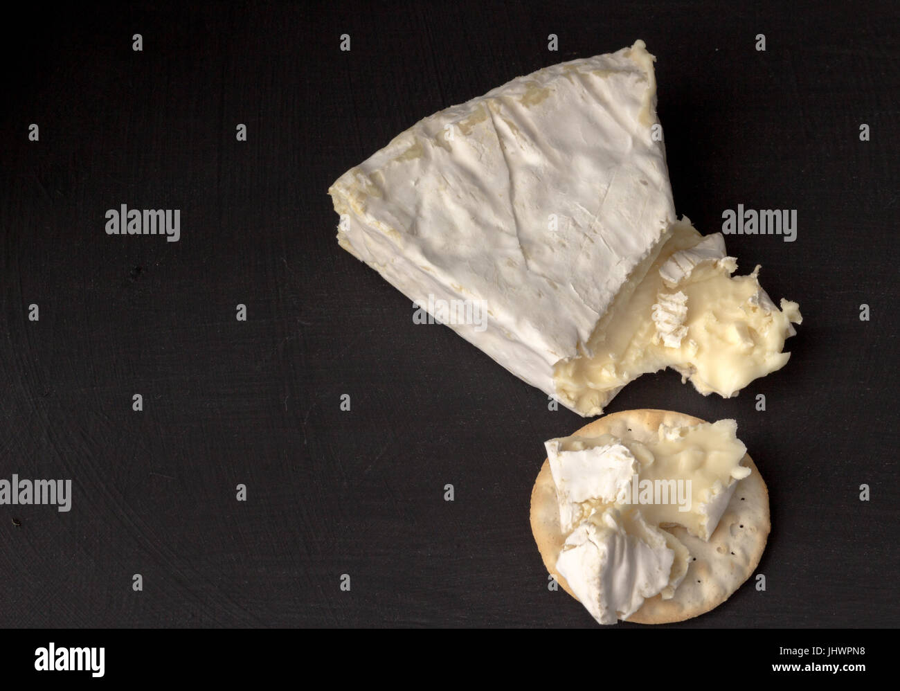 Brie type of cheese. Camembert cheese. Fresh Brie cheese wedge cut and