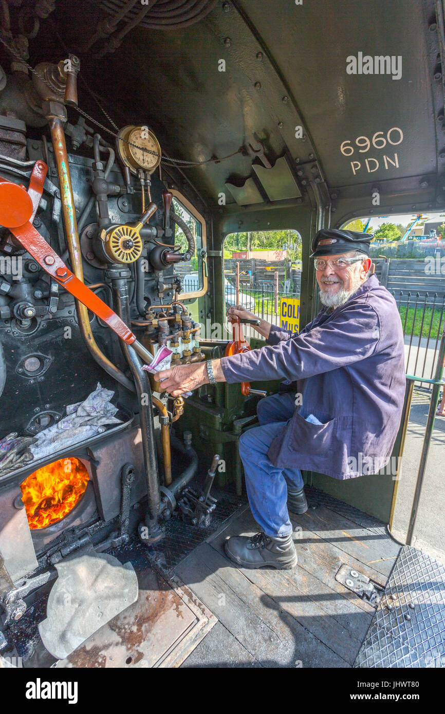 The driver of exGWR loco 6960 'Raveningham Hall' waits to depart from